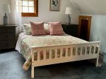 Upstairs bedroom with a queen bed